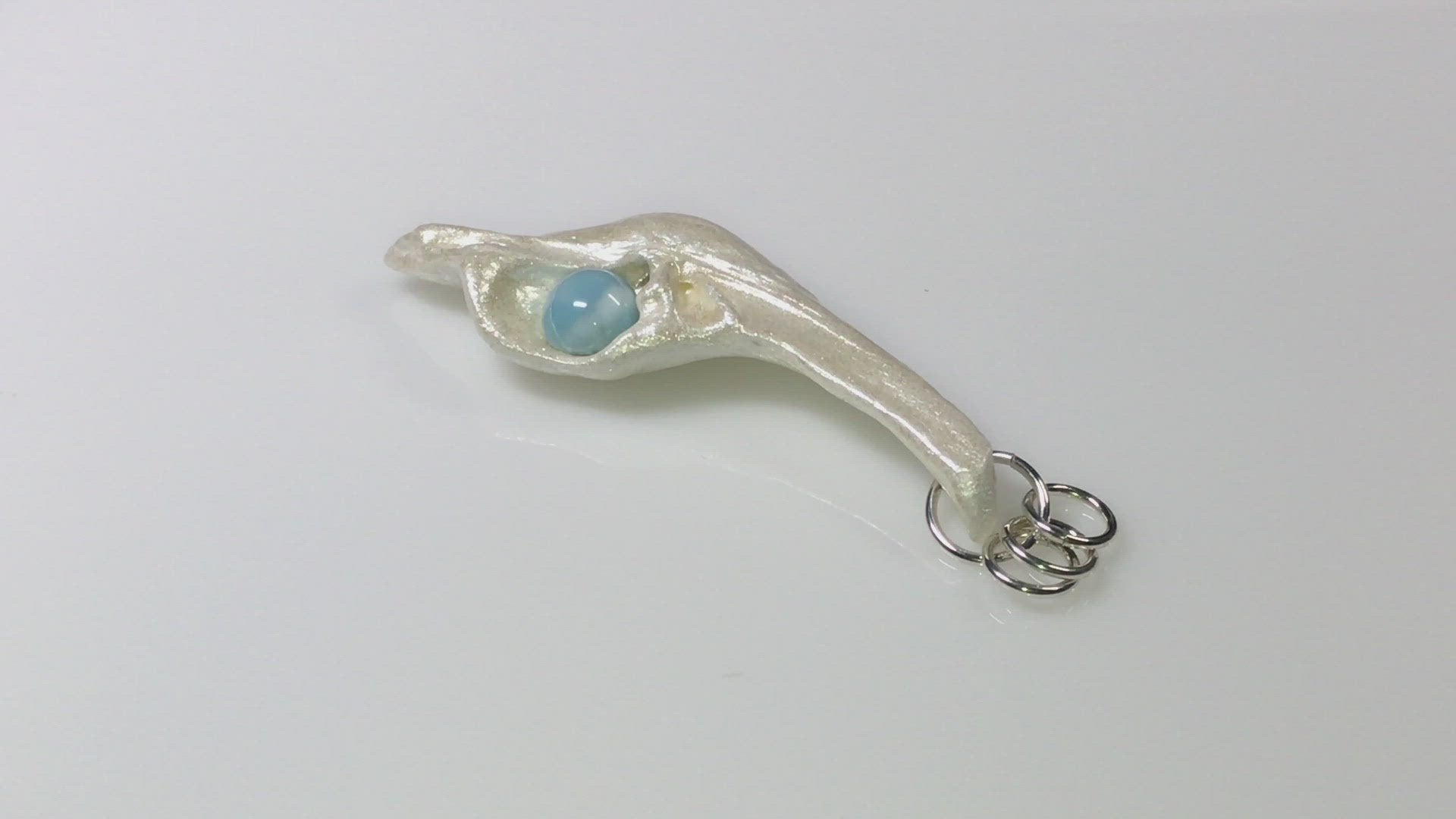 A video showcasing A beautiful 10 mm Round Larimar Gemstone&nbsp;compliments the pendant.