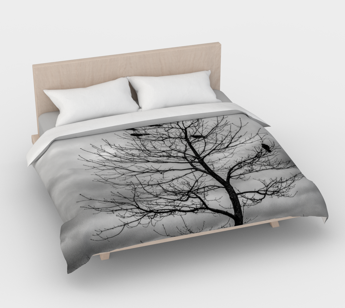 Cotton duvet cover on a king sized bed. The image on the duvet cover is that of Blackbirds such as a crow perched in a tree.
