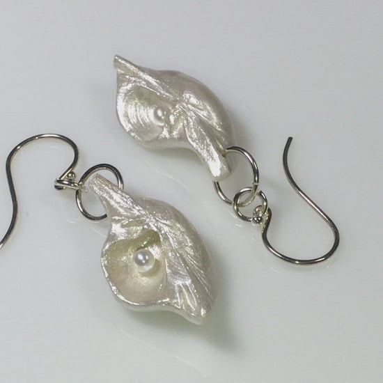 A video Harmony Earrings made of natural seashells and real freshwater pearls. 