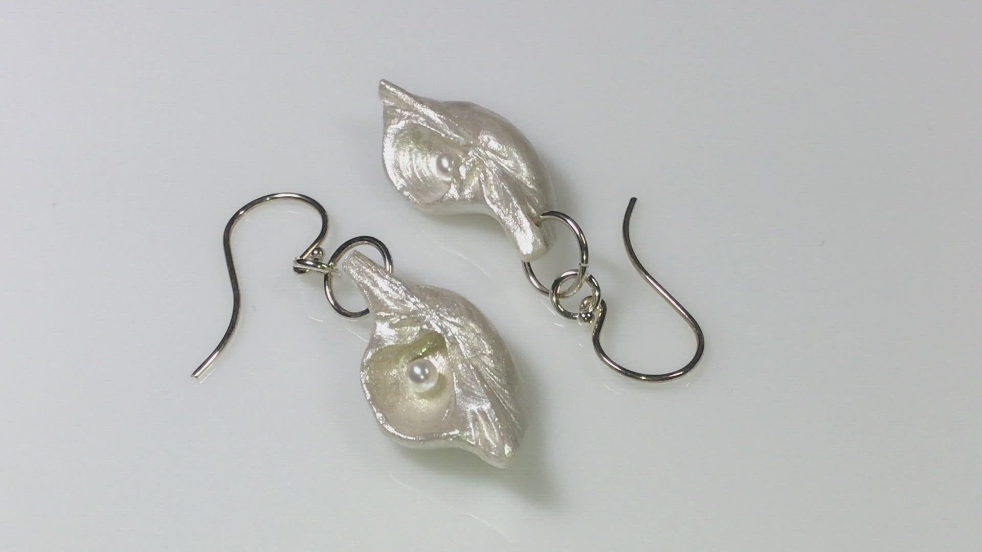 A video Harmony Earrings made of natural seashells and real freshwater pearls. 