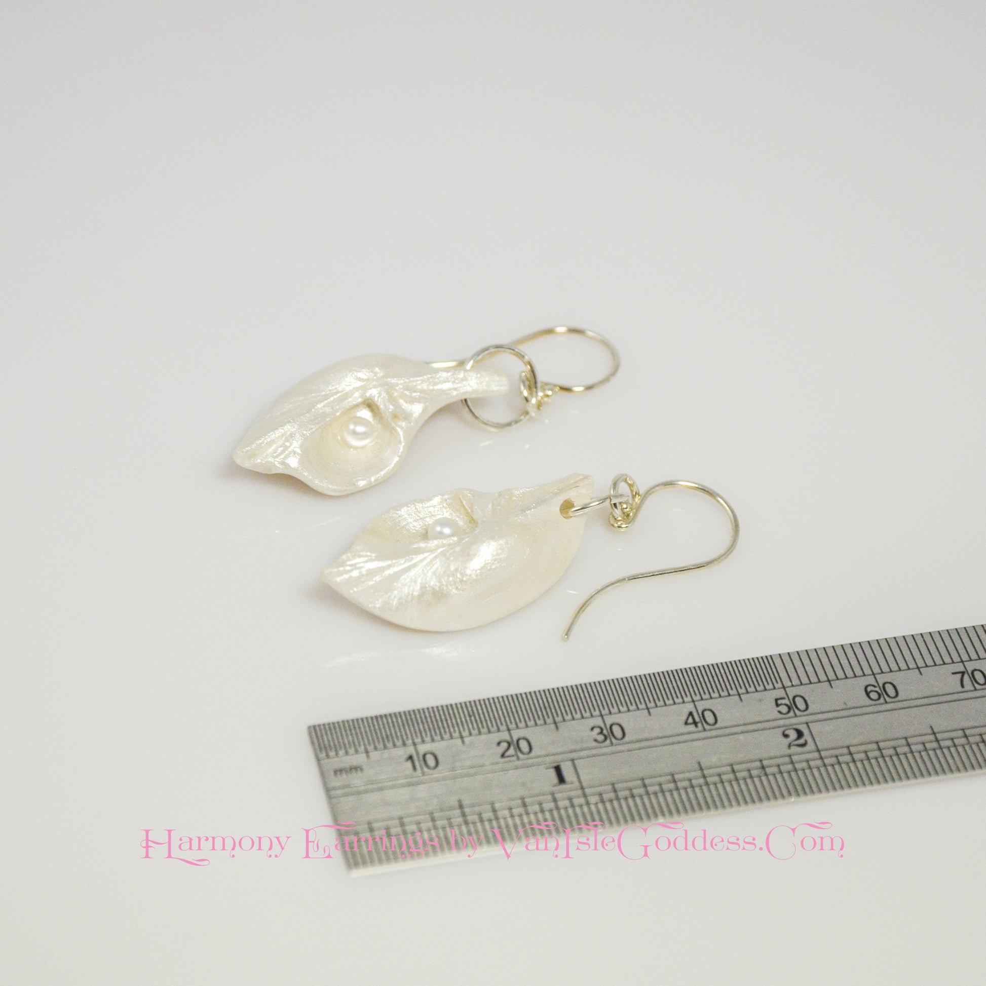 Harmony Earrings made of natural seashells and real freshwater pearls. The earring are shown along a ruler so the viewer can see the length of the earrings.