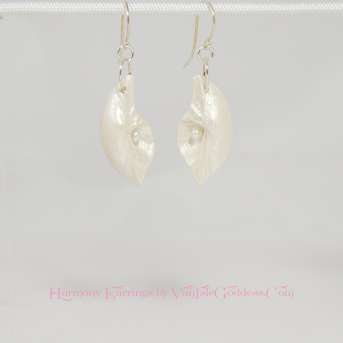 Harmony Earrings made of natural seashells and real freshwater pearls.  The earrings are shown hanging.