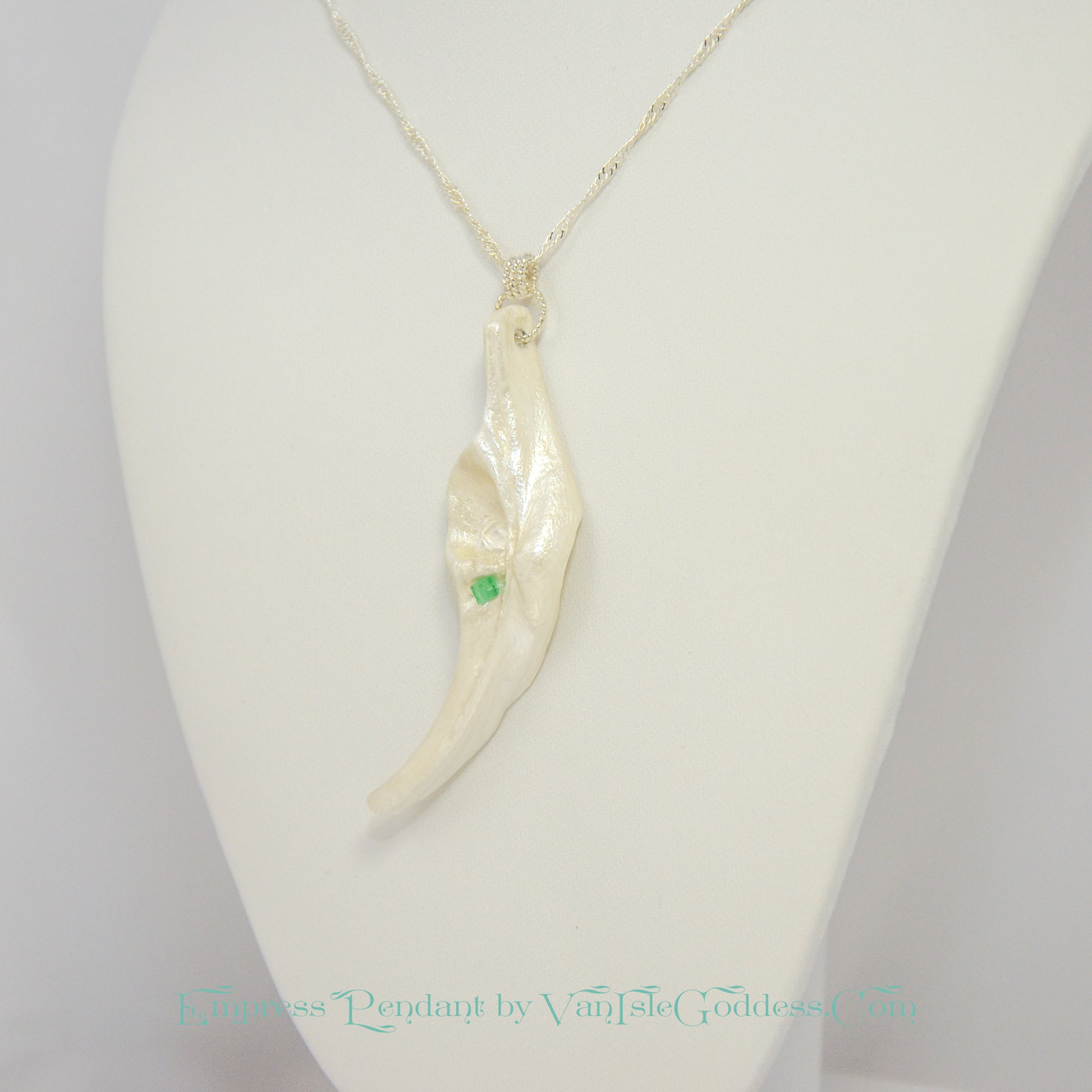 Empress natural seashell pendant with a Herkimer Diamond and Emerald. The pendant is turned to one side so the viewer can see what it looks like.