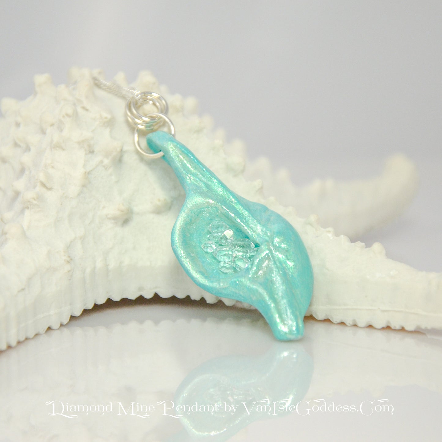Diamond Mine Pendant is named for the eight herkimer diamonds that enhance the beauty of this gorgeous pendant!  The pendant is resting on a starfish.  The print on the bottom of the image says: Diamond Mine Pendant by Van Isle goddess dot com