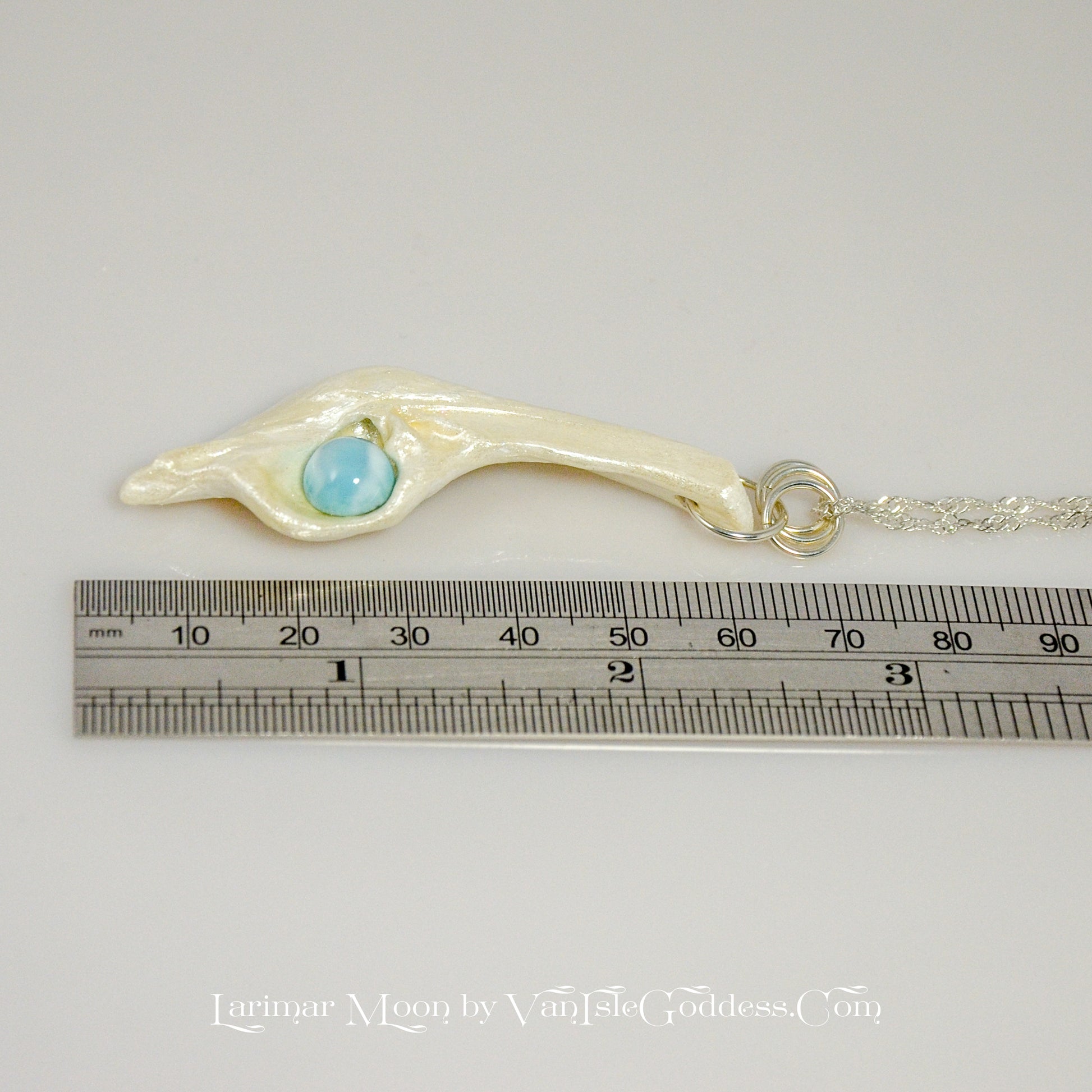 Larimar Moon Natural seashell a beautiful 10 mm Round Larimar Gemstone compliments the pendant. The pendant is shown along side a ruler so the viewer can see the length of the pendant.
