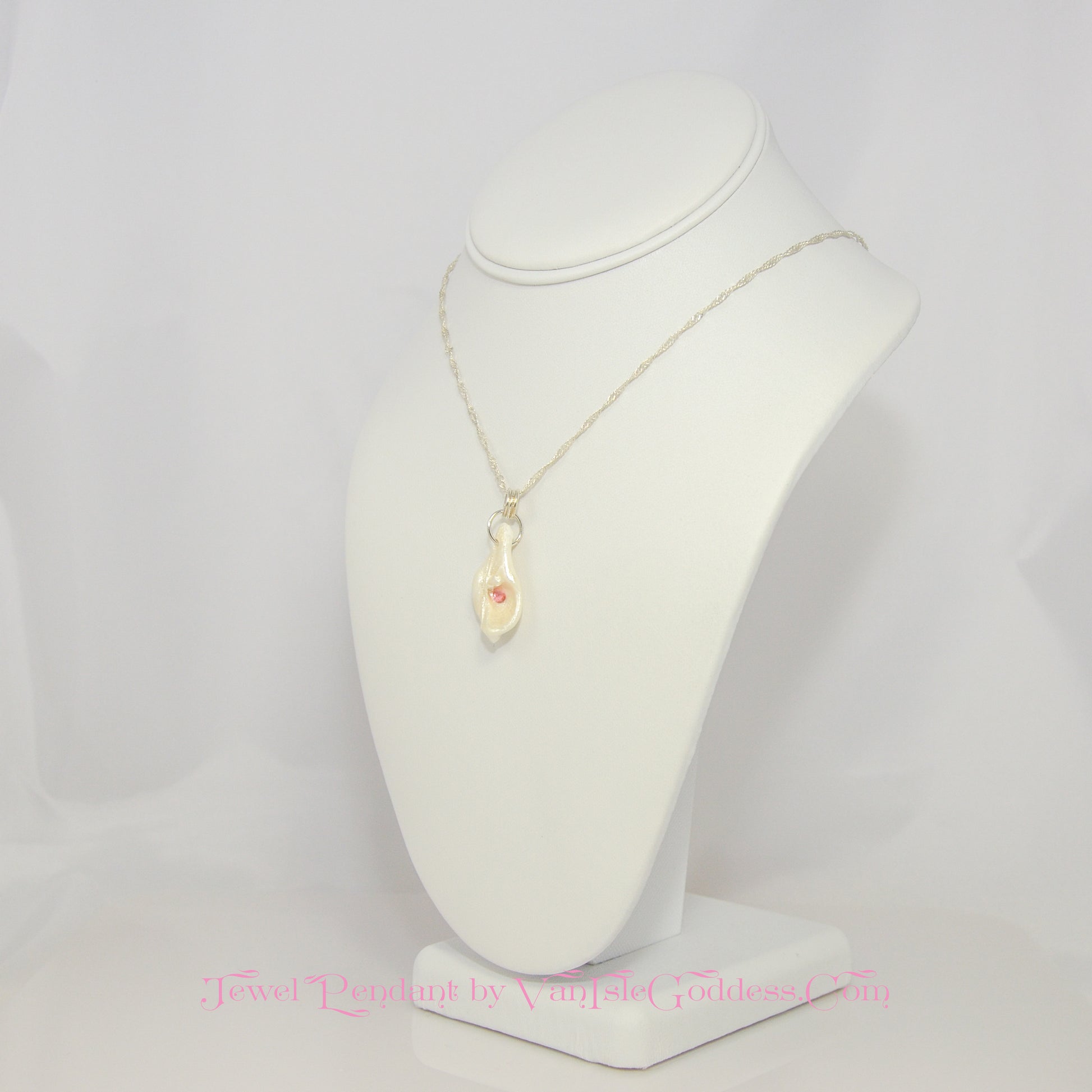 Jewel natural seashell with a real teardrop shaped rose cut pink tourmaline gemstone compliments the pendant. The pendant is shown so the viewer can see the left side of the pendant.