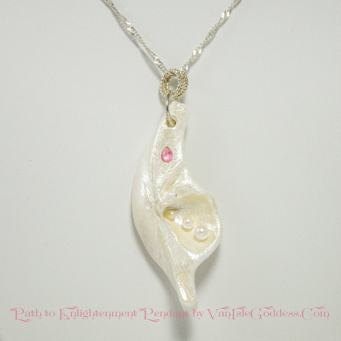 A trio of white baby freshwater pearls and a teardrop rose cut pink tourmaline gemstone compliments the seashell pendant beautifully.