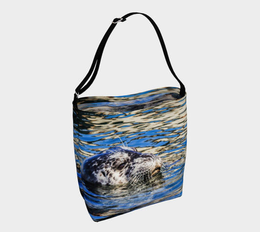 Seal of Blue Day Tote  Everyday Day Tote for Everything!  Van Isle Goddess ultimate tote bag!   Adjustable strap for comfort, the tote is made from soft and supple neoprene that stretches to fit whatever you can put in it!    Vibrant artwork that will never fade with washing.  Seal of Blue Artwork by  Roxy Hurtubise with blue interior.