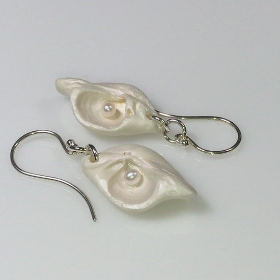 A video showcasing Serenity natural seashell earrings with real baby freshwater pearls.