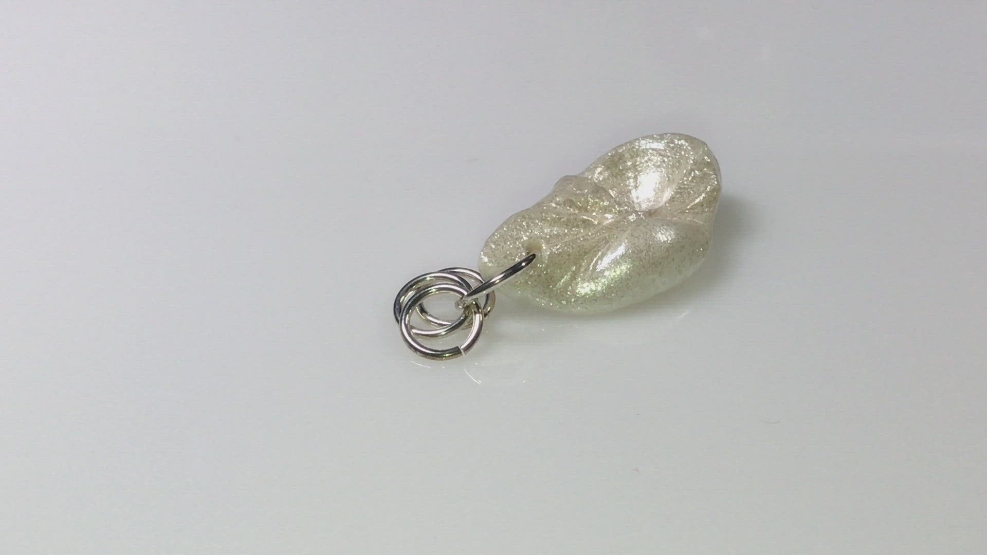 A video showing Jewel natural seashell with a real teardrop shaped rose cut pink tourmaline gemstone compliments the pendant. 