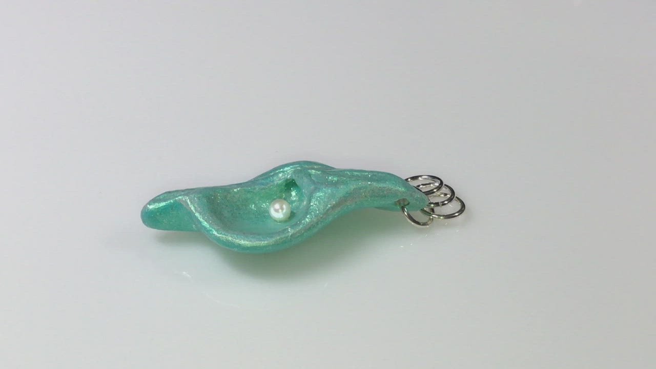 A video showcasing Ocean Pearl natural seashell pendant has a  real freshwater baby pearl. 
